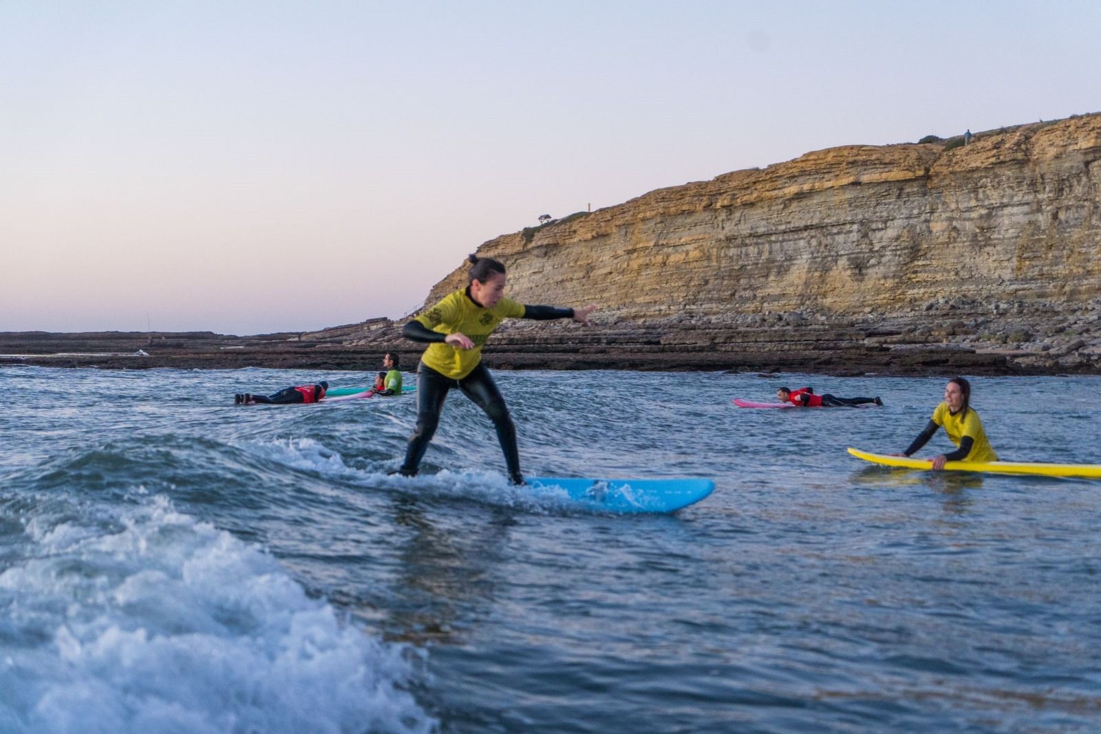 Beginner surf group learning together near the beach